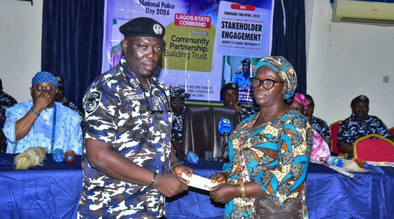 CP Fatai presenting a cheque to one of the beneficiaries.
