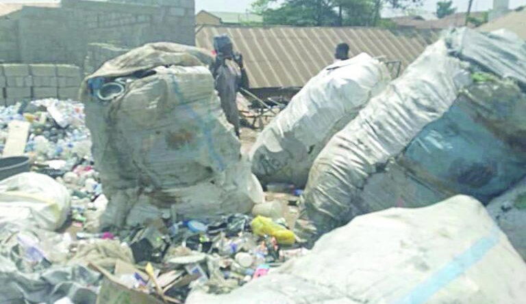 Across major roads and narrow inner streets, heaps of refuse spill from makeshift dumpsites onto the roadside. Black nylon bags burst open