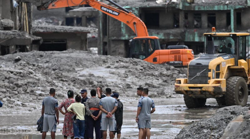Rescuers claw through mud as Nepal, China flood missing toll nears 3,000